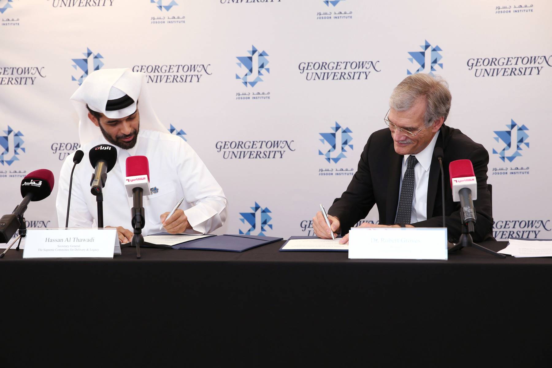Dr. Robert M. Groves and Mr. Hassan Al Thawadi Signing the Agreement