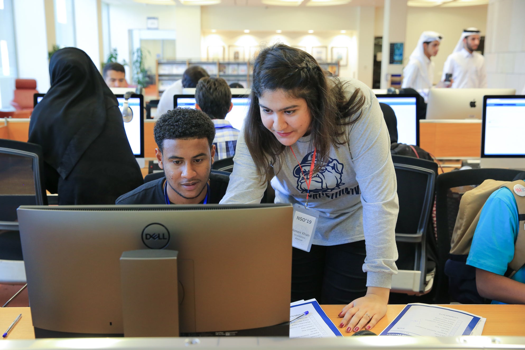 Student orientation advisor helps a new student during orientation.