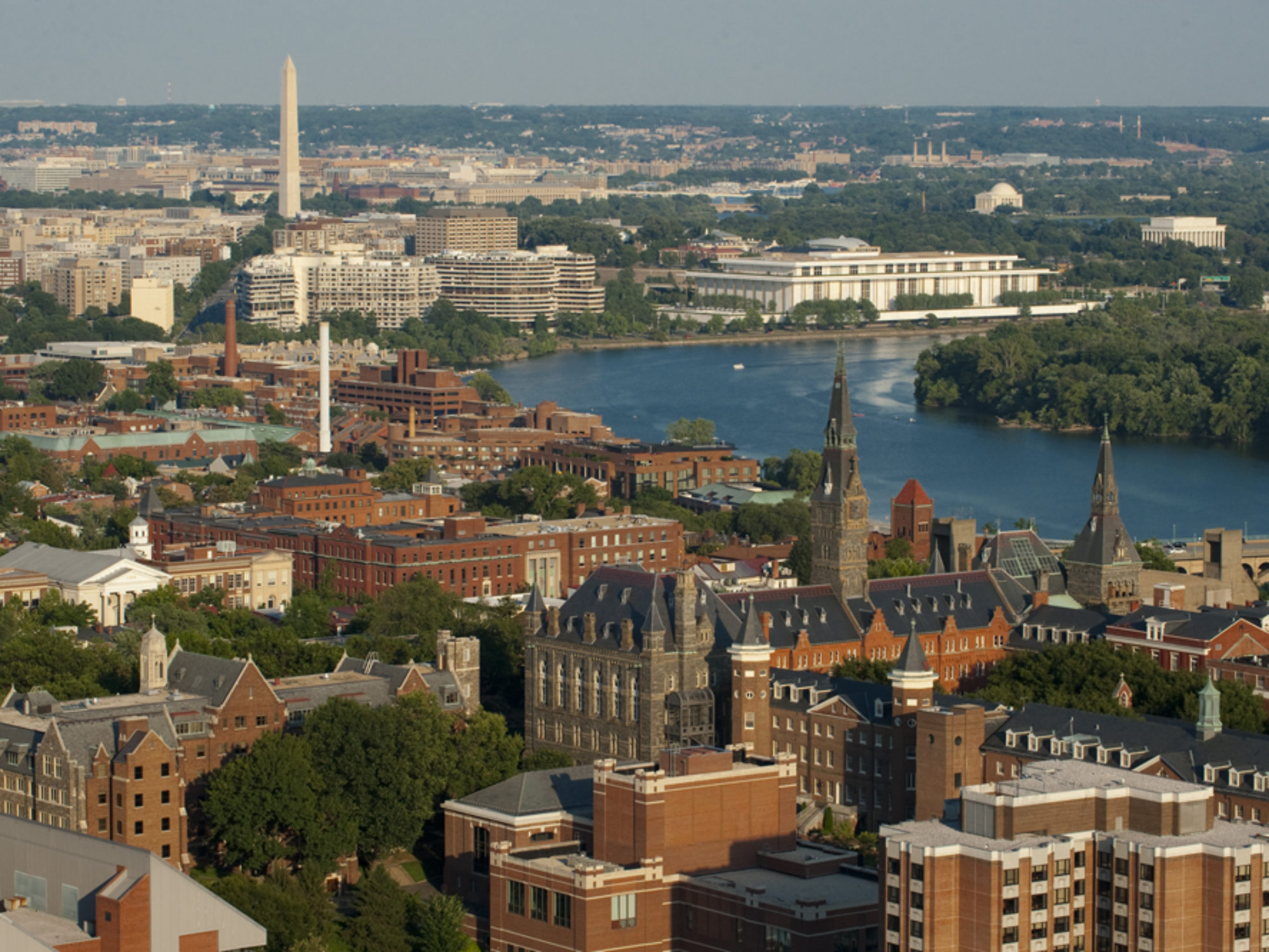 Aerial image of Washington DC Georgetown campus along the river with Washington monument in the background