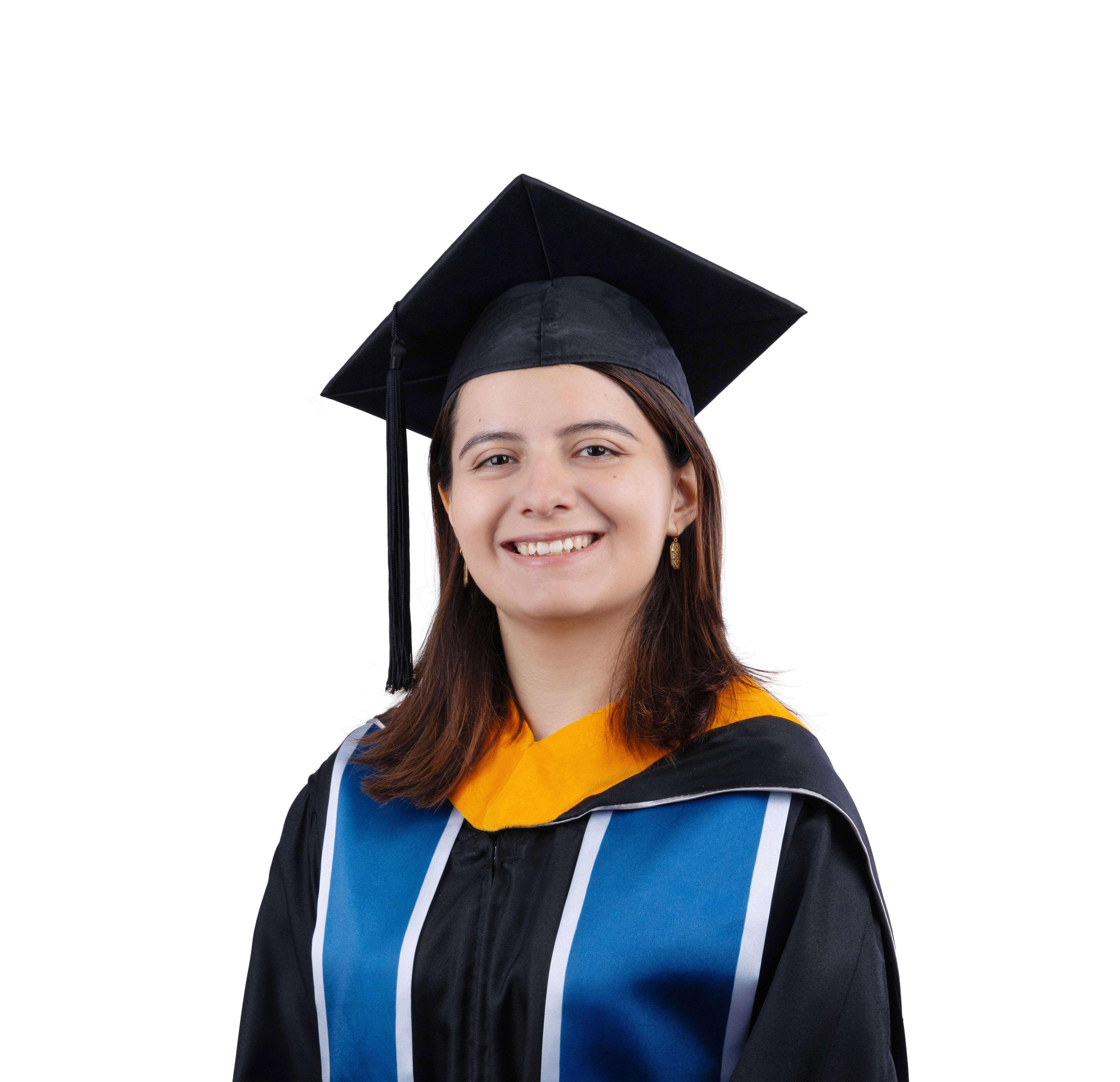 Emilia in a graduation cap and gown with yellow hood and blue ribbons