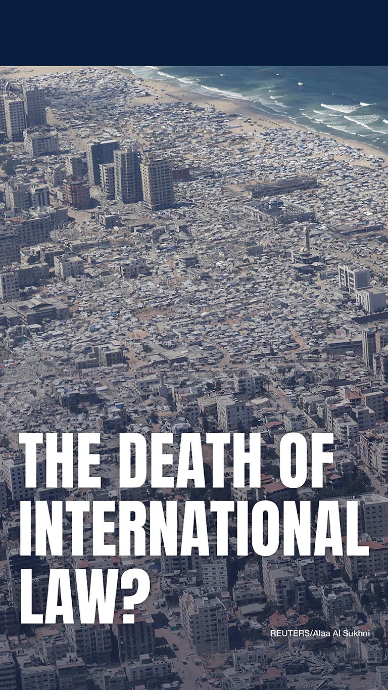 Aerial view of a densely packed urban area by the sea, with damaged buildings and debris. Large bold text reads, “THE DEATH OF INTERNATIONAL LAW?” with a photo credit to REUTERS/Aliaa Al Sukhni.